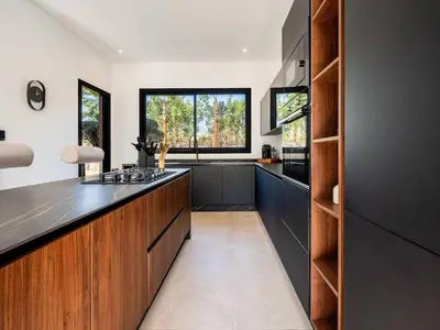 a kitchen with wooden cabinets and a counter top at Le Palais Zahira & Palais Mahora 2 villas in Marrakech