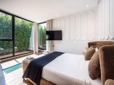 a bedroom with a large bed and a large window at Le Palais Zahira & Palais Mahora 2 villas in Marrakech