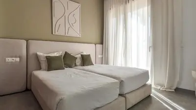 a bedroom with a large bed and a window at Beautiful AWAL Villa, 6 suites & heated pool in Marrakech