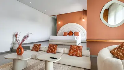 a living room with a couch and a bed at Beautiful AWAL Villa, 6 suites & heated pool in Marrakech