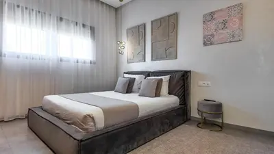 a bedroom with a large bed and a window at Beautiful AWAL Villa, 6 suites & heated pool in Marrakech