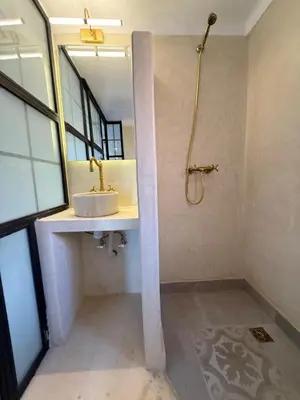 a bathroom with a sink and a shower at Beautiful modern triplex in Qariya Sayhia in Marrakech