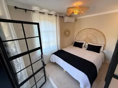 a bedroom with a large bed and a window at Beautiful modern triplex in Qariya Sayhia in Marrakech
