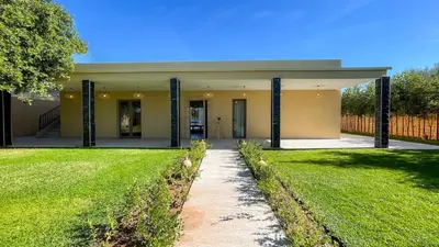 a house with a walkway in front of a yard at Villa JAMAL with heated pool in Marrakech in Marrakech