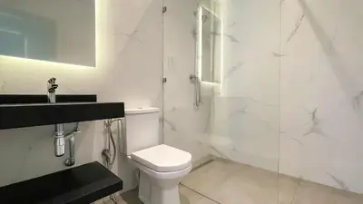 a bathroom with a toilet and a glass shower at Villa JAMAL with heated pool in Marrakech in Marrakech