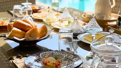 a table with plates of food on a table at Beautiful Asma Villa with heated pool in Marrakech