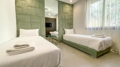 two beds in a bedroom with towels on them at Beautiful Asma Villa with heated pool in Marrakech