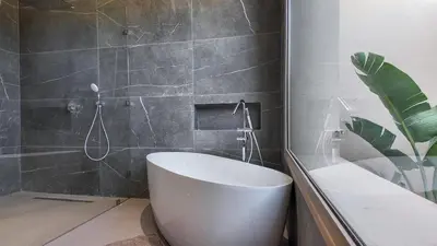 a bathroom with a white toilet and a shower at Villa Céleste avec piscine chauffée in Marrakech