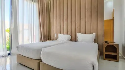 a bedroom with a large bed and a large window at Villa Nour heated pool not overlooked in Marrakech