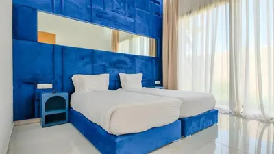 a blue bedroom with a bed with a blue headboard at Villa Nour heated pool not overlooked in Marrakech