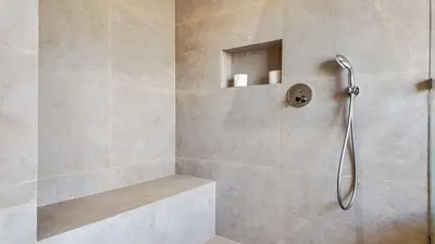 a shower with a glass door in a bathroom at Villa Delina heated pool not overlooked in Marrakech