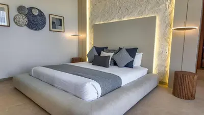 a bedroom with a large white bed with pillows at Villa Delina heated pool not overlooked in Marrakech