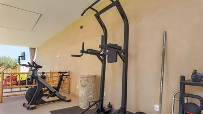 a gym with two exercise bikes and a treadmill at Villa Delina heated pool not overlooked in Marrakech