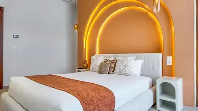 a bedroom with a white bed with an arch overhead at Villa Delina heated pool not overlooked in Marrakech
