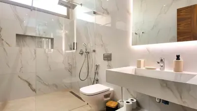 a white bathroom with a toilet and a sink at Villa Clea heated pool not overlooked in Marrakech