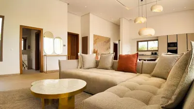 a living room with a couch and a table at Villa Clea heated pool not overlooked in Marrakech
