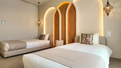 a room with two beds and a couch in it at Villa Clea heated pool not overlooked in Marrakech
