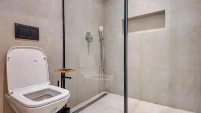 a bathroom with a toilet and a shower stall at Wintering Bungalow-Heated pool not overlooked in Marrakech