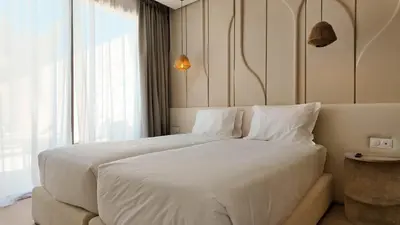 a large white bed in a room with a window at Majorelle Bungalow - Heated pool, not overlooked in Marrakech