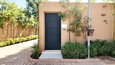 a blue door on the side of a building at Agdal Bungalow - Heated swimming pool, not overlooked in Marrakech