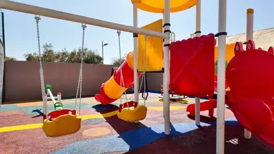 a playground with slides and swings at Agdal Bungalow - Heated swimming pool, not overlooked in Marrakech