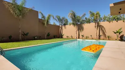 a pool with a float in the middle of it at Agdal Bungalow - Heated swimming pool, not overlooked in Marrakech