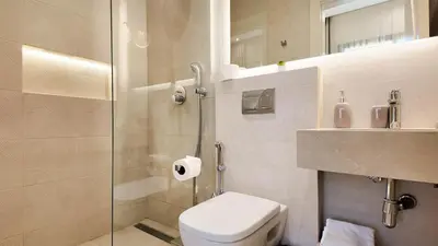 a bathroom with a toilet and a glass shower at Villa Maryam heated pool not overlooked in Marrakech