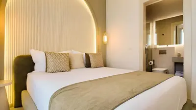 a bedroom with a large white bed in a room at Villa Maryam heated pool not overlooked in Marrakech