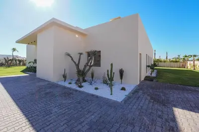 a white house with cacti in front of it at Villa Jibal heated pool not overlooked in Marrakech