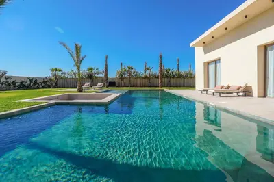 a swimming pool in the backyard of a house at Villa Jibal heated pool not overlooked in Marrakech