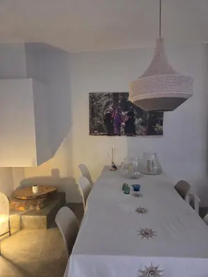 a dining room with a white table and chairs at Riad Yara Farah in Marrakech