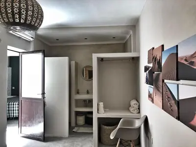 a bathroom with a white refrigerator and a chair at Riad Yara Farah in Marrakech