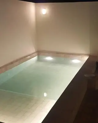 an empty swimming pool with lights in a room at Riad Yara Farah in Marrakech