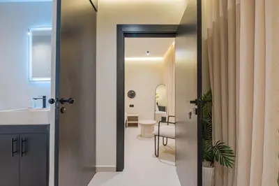 a bathroom with a door open to a bathroom with a toilet at Havre de paix moderne pour voyageurs exigeants in Marrakech