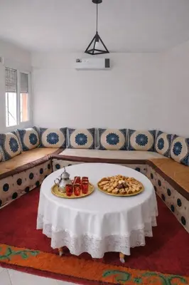 a room with a table with two plates of food on it at Appartement 2 Chambres Marrakech Targa Parking WiFi in Marrakech