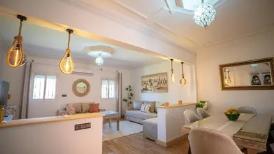 a living room with a couch and a table at Appt Duplex dans village touristique, sublime vue, proche médina in Marrakech