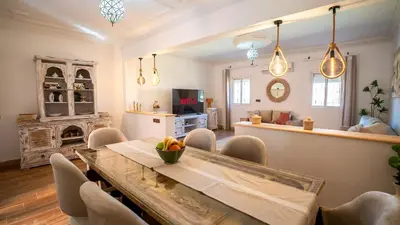 a living room with a table and chairs and a fireplace at Appt Duplex dans village touristique, sublime vue, proche médina in Marrakech