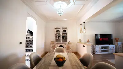 a living room with a table and a fireplace at Appt Duplex dans village touristique, sublime vue, proche médina in Marrakech