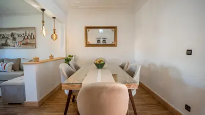 a dining room with a wooden table and chairs at Appt Duplex dans village touristique, sublime vue, proche médina in Marrakech