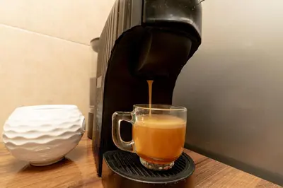 a coffee maker is making a cup of coffee at Dar Si Ahmed in Marrakech