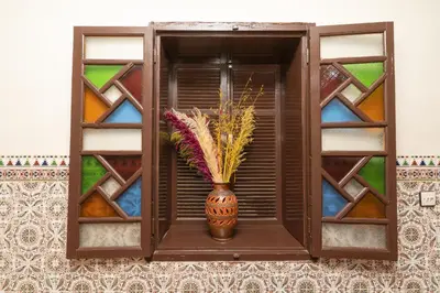 a vase sitting on a shelf with a window at Dar Si Ahmed in Marrakech