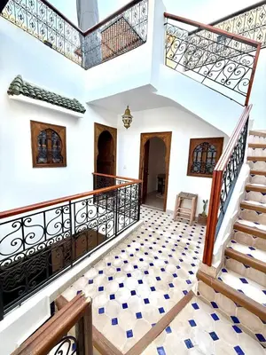 a staircase in a house with a tiled floor at Riad Oumhani in Marrakech