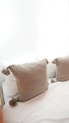 a bed with pillows on top of it at Riad Oumhani in Marrakech