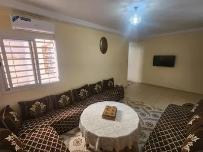 a living room with a couch and a table at Aéroport appartement Marrakech in Marrakech
