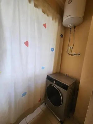 a washing machine in a room with hearts on the wall at Aéroport appartement Marrakech in Marrakech