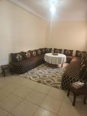 a living room with a couch and a table at Aéroport appartement Marrakech in Marrakech