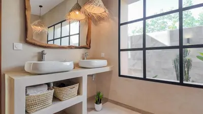 a bathroom with two sinks and a large window at Villa Maréa heated pool not overlooked in Marrakech