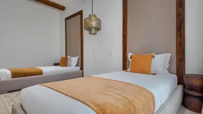 a bedroom with two beds and a couch at Villa Maréa heated pool not overlooked in Marrakech