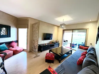 a living room with a couch and a table at Golf Prestigia Marrakech in Marrakech