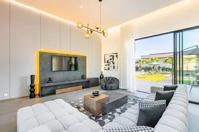 a living room with a couch and a tv at Villa Prestige Privée avec Vue Splendide in Marrakech